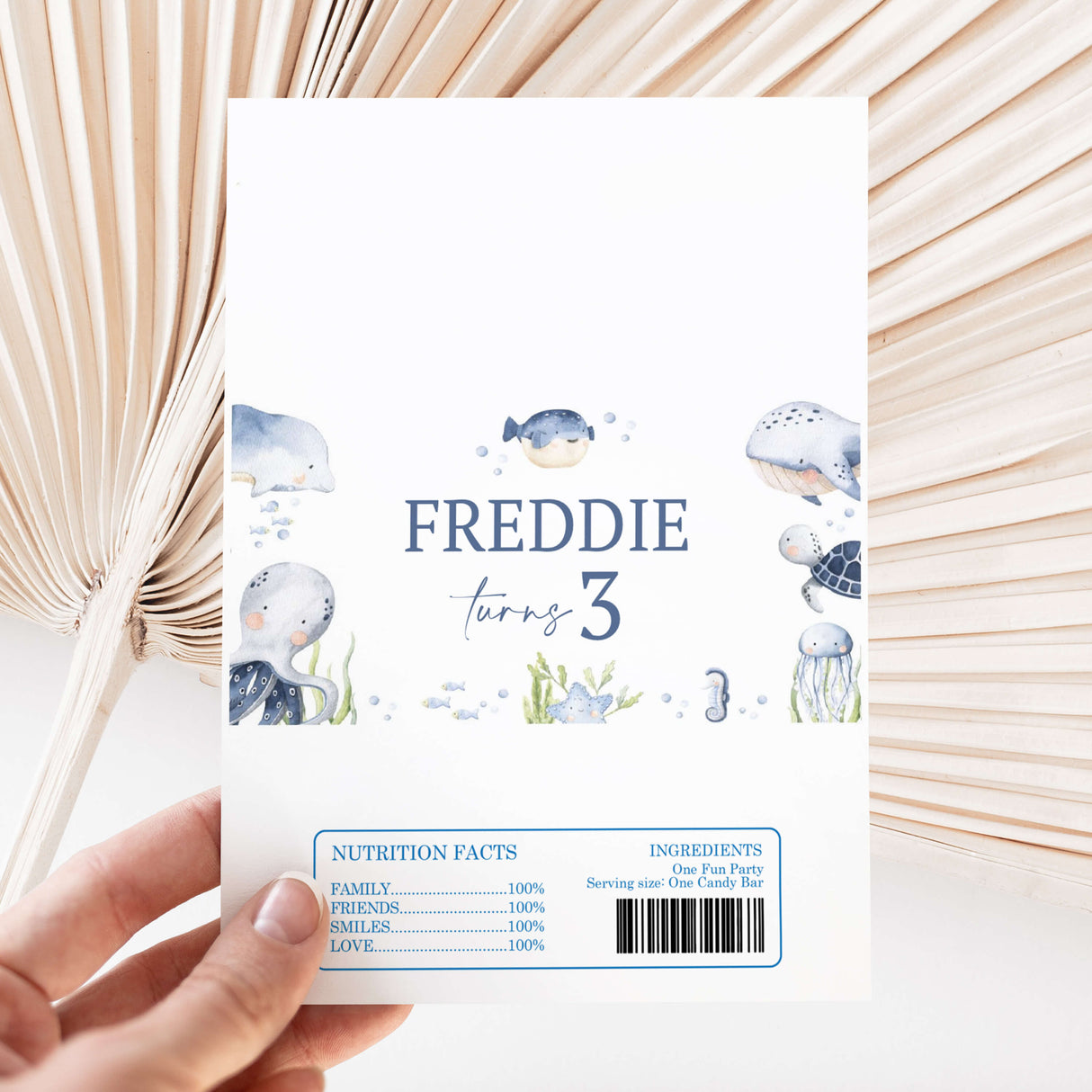 Ocean animal printed chocolate wrapper with “Freddie turns 3” and barcode label