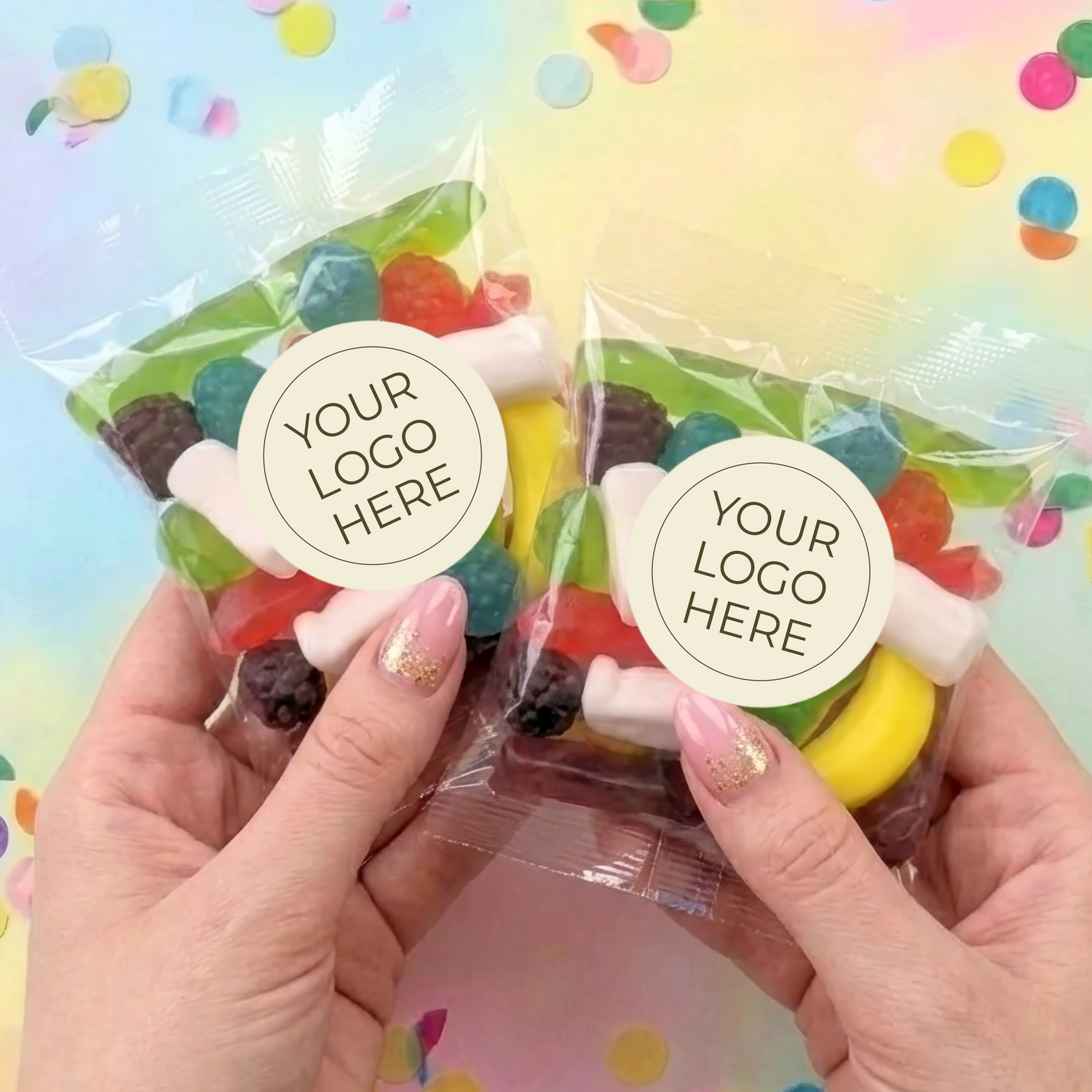 Two personalised lolly bags held in hands, each with YOUR LOGO HERE label and mixed sweets