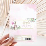 Pink chocolate bar wrapper with bunny illustration, flowers, and Hazel's First Birthday text
