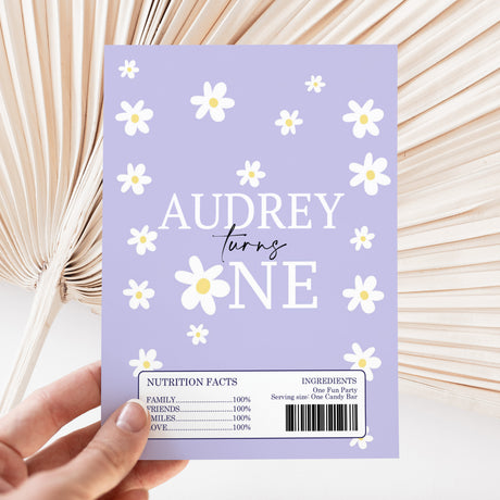 Purple chocolate bar wrapper with white daisies and 'AUDREY turns FIVE' text