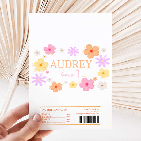 Chocolate wrapper sheet with floral daisies and text “AUDREY turns 1” plus barcode