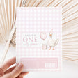 Pink first birthday chocolate wrapper with gingham, goose, balloon, and Hailey is One text
