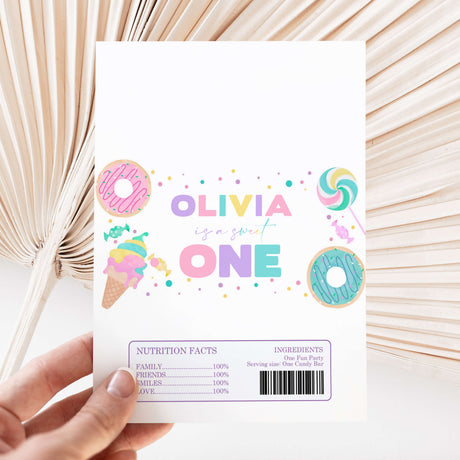 Printed chocolate wrapper sheet with “OLIVIA ONE” and nutrition facts on reverse
