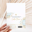 White chocolate wrapper with gold splatter, cross, and “Thank you for celebrating” text