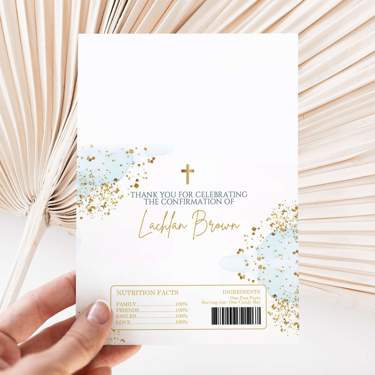 White chocolate wrapper with gold splatter, cross, and “Thank you for celebrating” text